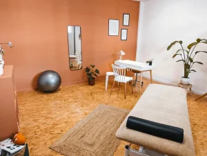 Box individuel pour pratiquer la kinésithérapie. Dans la pièce, il y a un bureau, une table de massage.